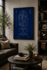 Framed Blueprint style print above a sofa in a warm living room